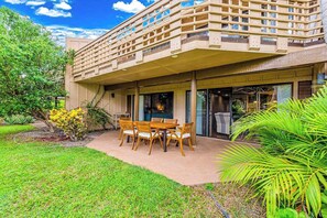 A modern building with a covered patio, outdoor seating, and lush greenery. - *New* Fall Sale Molokai Two-Bedroom Retreat by Kepuhi Beach (Maunaloa)