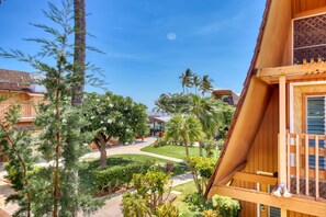A resort with wooden buildings, a clear sky, and a well-maintained garden with various trees and plants. - Oceanfront Hotel Molokai 201 Studio Near Kaunakakai | Pool/Beach Access, Hammock (Kaunakakai)