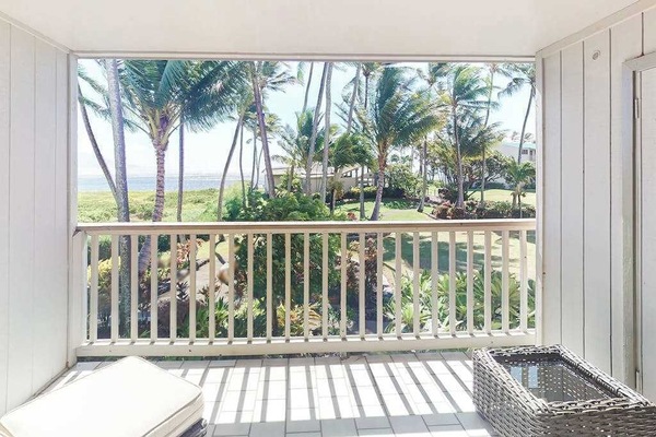 Balcony seating overlooks tropical grounds and sparkling Pacific waters nearby