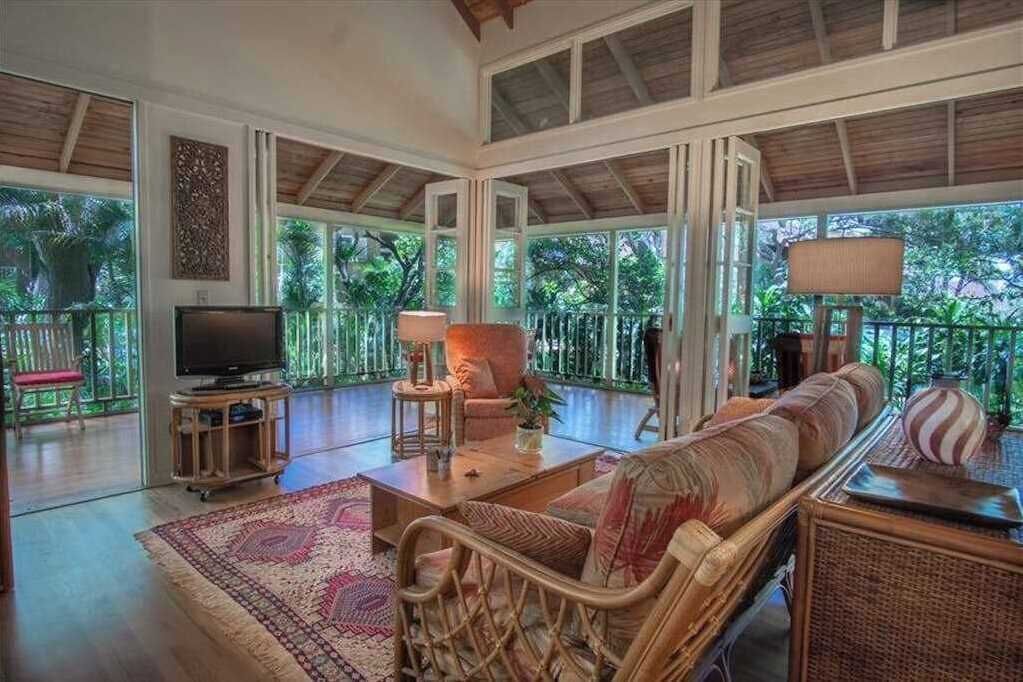 Living room features inviting seating television and bright natural light