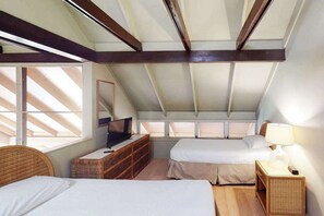 A bedroom with two beds, a TV, a dresser, and a window with blinds. - NEW Fall Special Oceanfront Molokai Cottage Steps from Kepuhi Beach (Maunaloa)