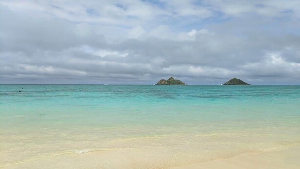 A beach with clear turquoise water and distant islands under a cloudy sky. - *New* 30-Night Waikiki Studio with Lanai and Pool (Honolulu)