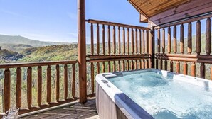 A wooden deck with a hot tub and a view of mountains. - Brave Eagle (Gatlinburg)