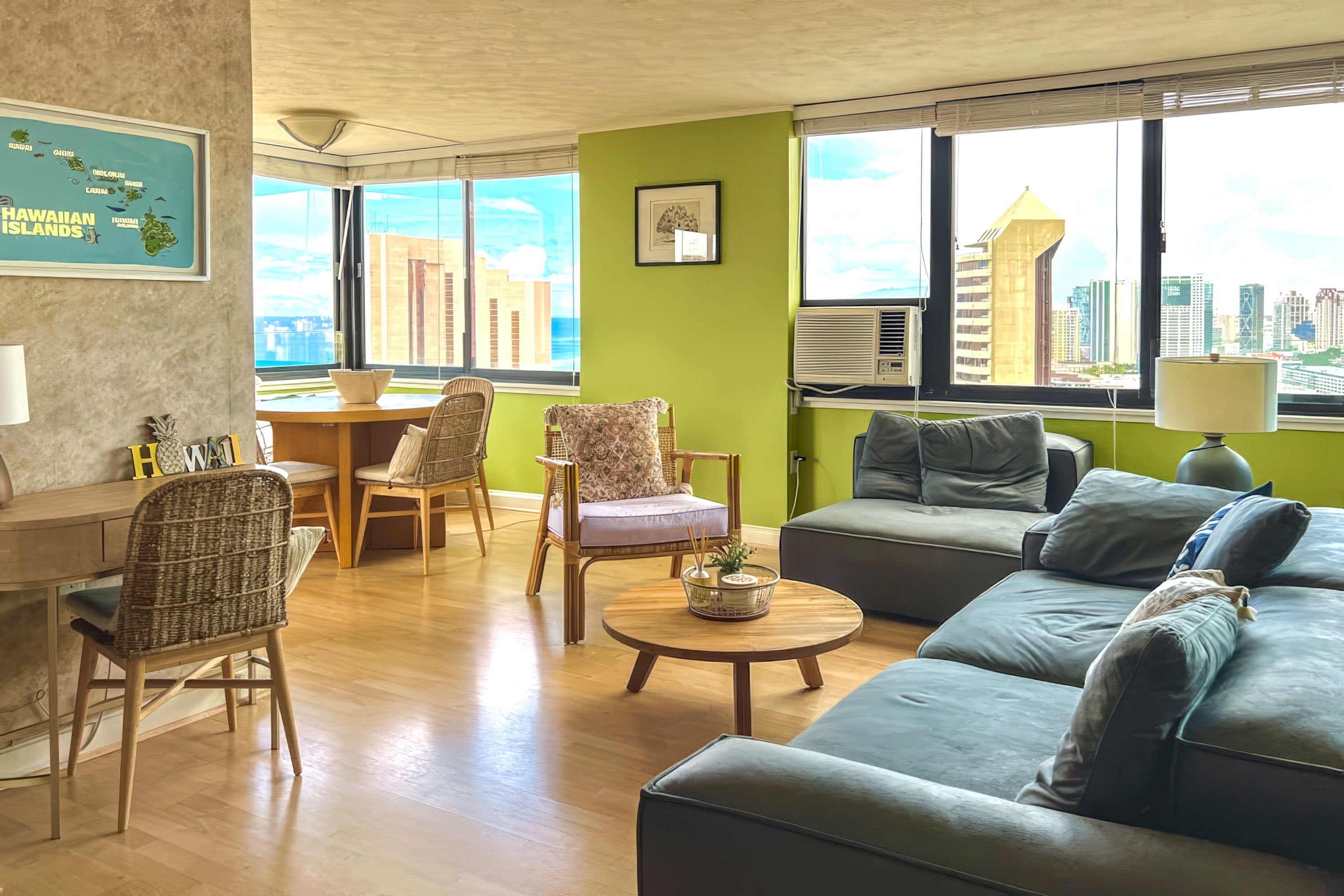 A modern living room with a green accent wall, a sofa, chairs, a dining table, and large windows with a city view.