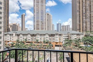 A residential building complex with multiple apartment buildings, a parking area, and a landscaped garden. - New Fall $ale Waikiki Studio with City-View Balcony One Block from the Beach (Honolulu)