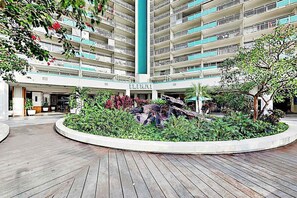 A multi-story hotel with a central courtyard featuring a rock garden and a fountain. - NEW Marina Sunsets from an 11th-Floor Ilikai Studio (Honolulu)