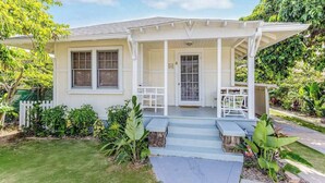 A single-story house with a porch, a front door, and a small garden area. - *NEW* Diamond Head Cottage Near Waikiki, 30-Night Minimum (Honolulu)