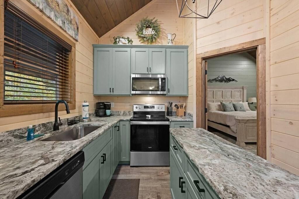 A compact kitchen with a built-in oven, a microwave, and a sink.