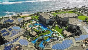 A resort with multiple buildings, a swimming pool, and solar panels. - NEW Fall Deal Water-Slide Resort Days at Oceanfront Waipouli (Kapaa)