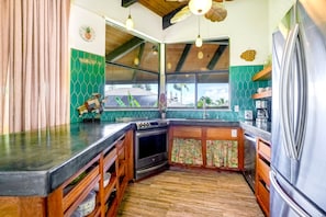 A kitchen with a wooden countertop, a stove, and a refrigerator. - NEW Fall Deal A Sunlit Princeville Great Room Near Hanalei and Anini (Princeville)