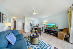A modern living room with a sofa, coffee table, and a television. - *NEW* Fall $pecial Beachside Kapaa Condo with Three Pools and Hot Tubs (Kapaa)