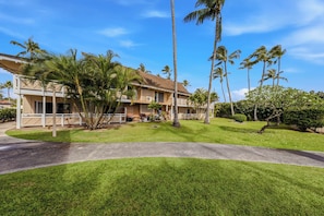 A two-story hotel with a flat roof, multiple balconies, and a well-maintained lawn. - Ground-Floor Kapaa Retreat 250 Yards from the Beach (Kapaa)