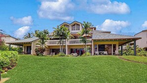 A two-story house with a covered patio, a lawn, and a small garden area. - *NEW* Air-Conditioned Poipu Retreat, 100 Yards from Brennecke's (Koloa)