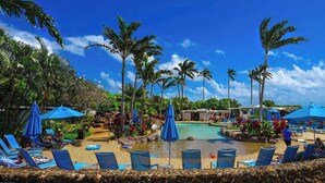 A poolside area with lounge chairs and umbrellas, surrounded by palm trees and a clear blue sky. - *NEW* Air-Conditioned Poipu Retreat, 100 Yards from Brennecke's (Koloa)