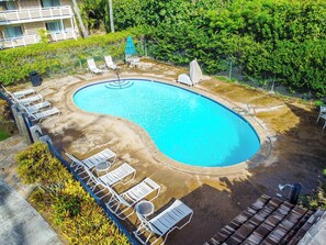 A swimming pool with lounge chairs and a covered seating area, surrounded by greenery. - New Fall Sale Mountain-View Kapaa Getaway Near Beach and Marketplace (Kapaa)