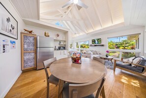 A modern kitchen with a refrigerator, microwave, and wooden cabinets. - Anini Beach Ke Hale Olu Family Retreat Cottage- Steps to Sand - Kitchen, WD, BBQ (Kilauea)