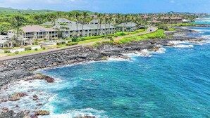 A coastal hotel with multiple buildings, a rocky shoreline, and clear blue ocean. - *New* Fall Special Poipu Waterfront Home with Athletic Club Perks (Koloa)