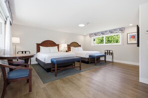 A hotel room with two beds, a desk, chairs, a window with a view, and a lamp. - Wilder Inn South Wellfleet, Outset Collection by Hilton (Wellfleet)
