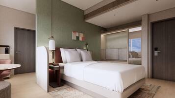 A modern hotel room with a large bed, bedside tables, a desk, and a seating area.