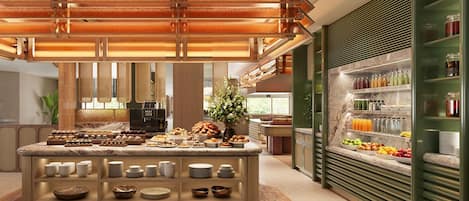 A modern breakfast bar with a variety of pastries and a coffee machine, surrounded by a green-framed beverage refrigerator stocked with drinks.