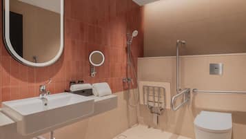A modern bathroom with a large sink, a mirror, a shower, and a toilet.