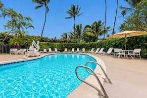 A swimming pool with lounge chairs and palm trees. - NEW Fall Sale Cool-Off Pools and Coconut Coast Days in Kapaʻa (Kapaa)