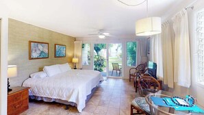 A bedroom with a bed, a desk, a chair, and a TV. - New Ground-Floor Kauaʻi Studio With Ocean View and Lanai (Kapaa)