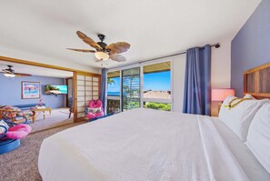 A hotel room with a large bed, a ceiling fan, a television, and a view of the ocean. - Making Makahuena Memories in 2204 Villa- Pool/Ocean Views, Hot Tub, Kitchen+WIFI (Koloa)