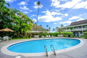 A swimming pool with lounge chairs and umbrellas, surrounded by tropical vegetation. - NEW Fall Sale Kapaa King Condo, 2-Minute Walk to the Ocean (Kapaa)
