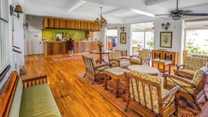 A spacious lobby with wooden flooring, a reception desk, and a seating area with patterned chairs and a sofa. - *New* Ocean-View Kapaa Studio by the Beachside Pool (Kapaa)