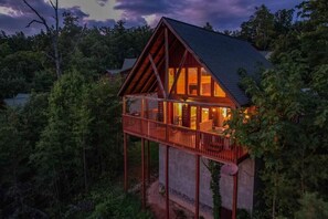 A cabin with a balcony, surrounded by trees. - Kick Back Shack (Sevierville)