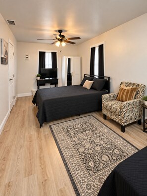 A bedroom with a bed, a chair, a television, a wardrobe, and a ceiling fan. - Charming 3-bedroom house in Brownsville with cool AC breeze (Brownsville)