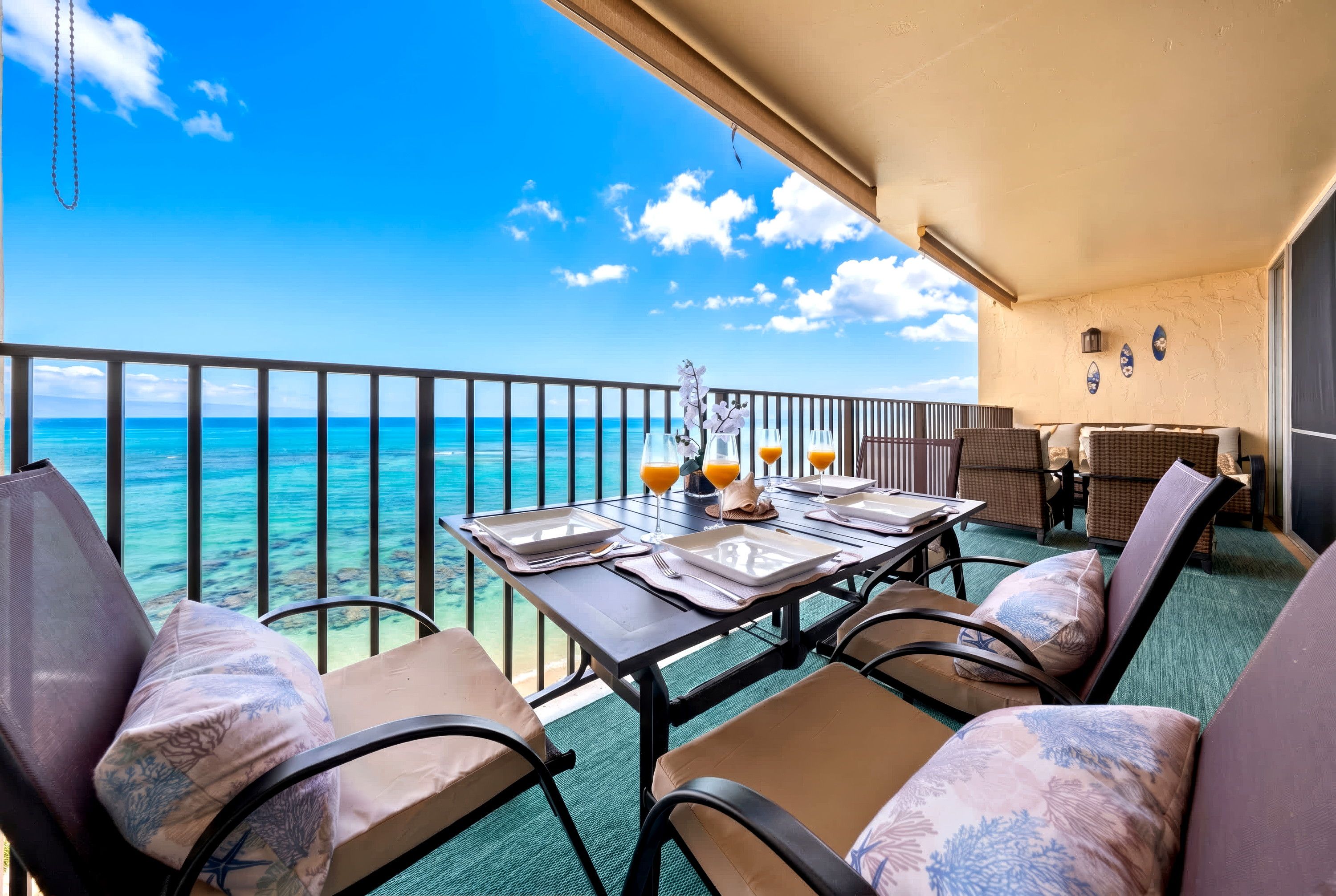 Ein Balkon mit Tisch für zwei Personen, mit Blick auf das klare, blaue Meer.