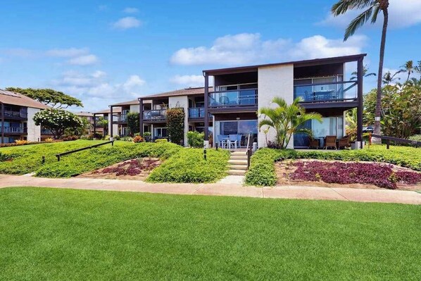 A modern hotel with multiple floors, outdoor seating, and well-maintained landscaping. - NEW Fall Deal Sea-View Kihei Condo for Four Across from Kamaole III (Kihei)