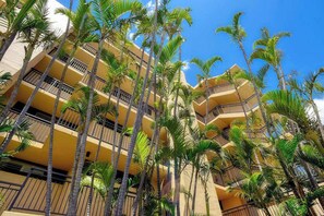 A multi-story hotel with balconies and palm trees. - New Fall Sale Ocean-View Sugar Beach Penthouse with Pool and Hot Tub (Kihei)
