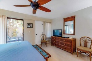 A bedroom with a bed, a television, a dresser, a chair, and a ceiling fan. - *New* Fall Special Kihei Condo with Pools and Tennis Near Kamaole III (Kihei)