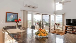 A kitchen with a fruit bowl, a sink, and a television. - NEW Fall Sale Ocean-View Wailea Townhouse with Two Shaded Lanais (Wailea)