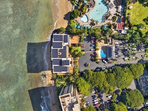 An aerial view of a resort with a beach, a swimming pool, and solar panels on the buildings. - *New* Fall Sale Connecting Honokowai Ocean-View Suites for Eight (Lahaina)