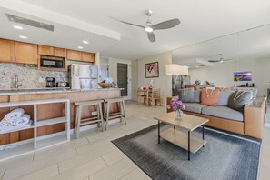 A modern apartment with a kitchen, dining area, and living room. - *NEW* Fall $pecial Ground-Floor Beachfront Lahaina Condo with Pool (Lahaina)