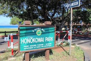 A sign for Honokowai Park with park hours and a one-way street sign. - *NEW* Fall $pecial Ground-Floor Beachfront Lahaina Condo with Pool (Lahaina)