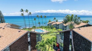 A resort with a pool, palm trees, and ocean views. - Ground Floor Mahina Surf Oceanfront Condo at Turtle Beach- Pool, Kitchen, WD, TV (Lahaina)