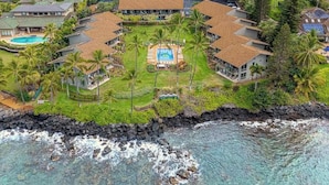 A resort with multiple buildings, a central pool, and a rocky coastline. - *NEW* Fall Deal Lofted Ocean View Family Stay at Mahina Surf (Lahaina)