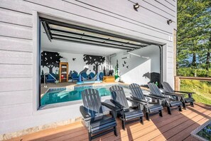 A poolside area with lounge chairs, a pool, and a view of the outdoors. - Top of the Summit Lodge (Sevierville)