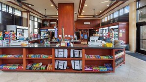A spacious lobby with a central counter, ceiling fans, and a large window. - NEW Ocean-View Keawakapu Beach Suite for Four (Kihei)