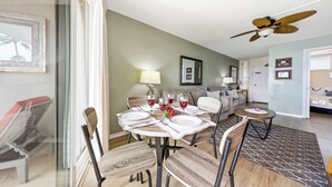 A dining area with a round table, chairs, and a ceiling fan. - *New* Fall Special Oceanfront Honokōwai Retreat with a Spacious Lanai (Lahaina)