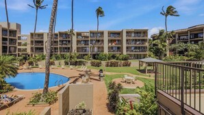 A hotel with multiple floors, outdoor pools, and palm trees. - *New* Fall Special Oceanfront Honokōwai Retreat with a Spacious Lanai (Lahaina)