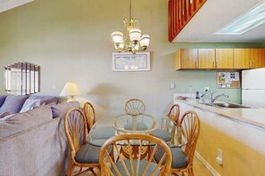 A compact living space with a dining area, kitchenette, and a sofa. - NEW Fall $pecial Family Beach Days Across from Kamaole III in Kihei (Kihei)