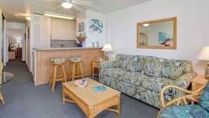 A compact living space with a kitchenette, a sofa, a coffee table, and a dining area with stools. - *NEW* Oceanfront Ma'alaea Hideaway Near Harbor Adventures (Wailuku)
