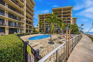 Um hotel com várias varandas, piscina e vista para a praia.