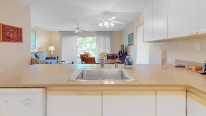A kitchen with a sink, cabinets, and a ceiling fan. - NEW Fall Sale Garden-View Kihei 1BR with Pools and Tennis (Kihei)